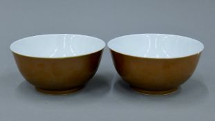 Two Chinese brown glazed bowls, each underside with blue painted six character mark.