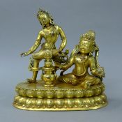 A large gilt bronze figure of a double deity. 28 cm high.