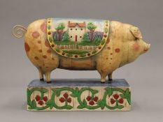 A decorative model of a pig. 26 cm long.