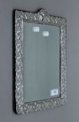 A silver dressing table mirror (lacking strutt). 36.5 cm high.