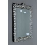 A silver dressing table mirror (lacking strutt). 36.5 cm high.