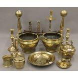 A large quantity of brassware, including candlesticks, fire dogs, etc.