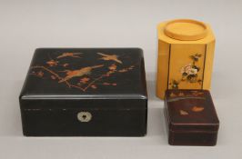 Two lacquered boxes and a Chinese tea caddy. The latter 12.5 cm high.