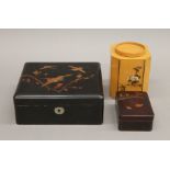 Two lacquered boxes and a Chinese tea caddy. The latter 12.5 cm high.