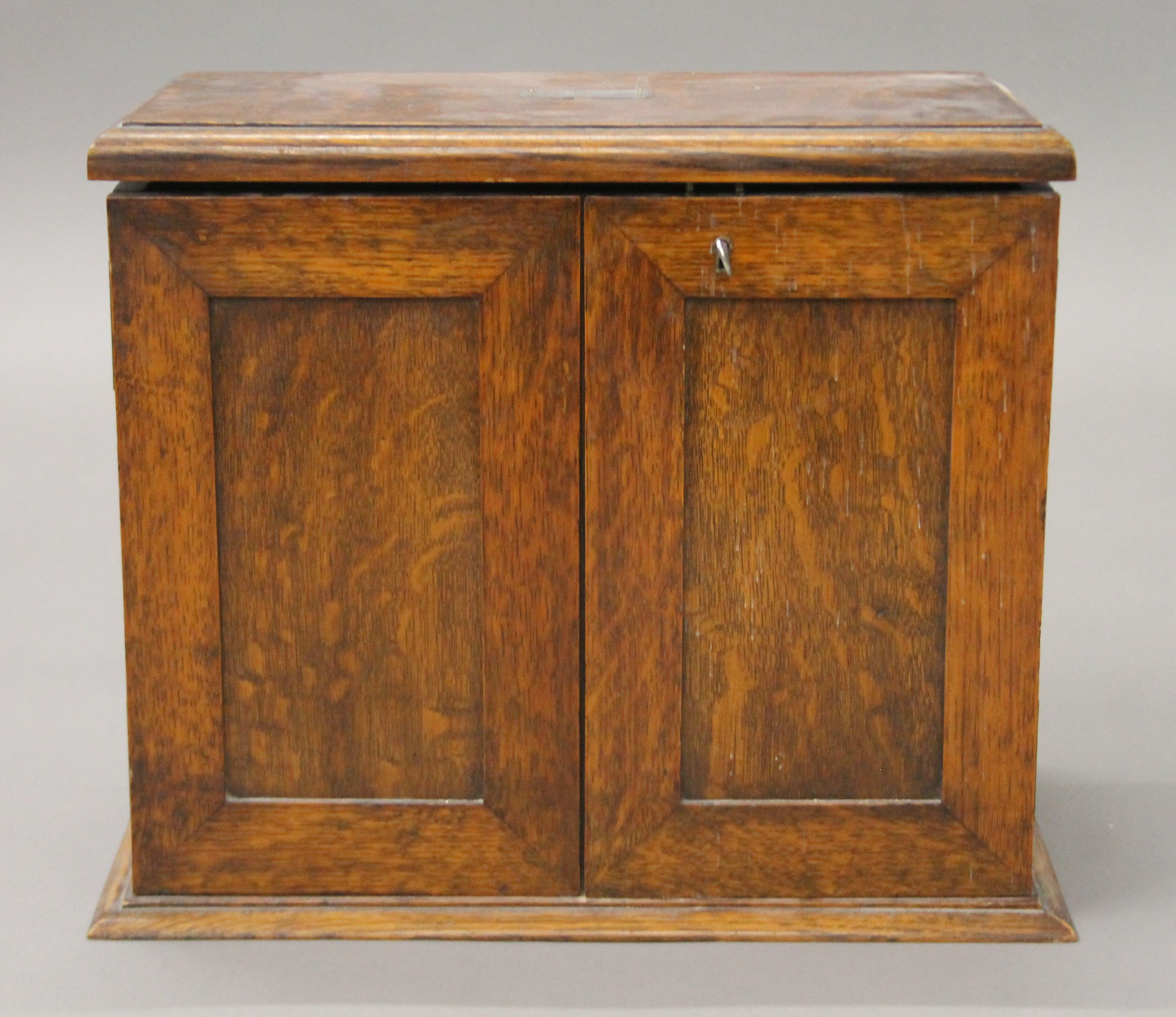 An early 20th century oak smoker's cabinet. 37 cm wide.