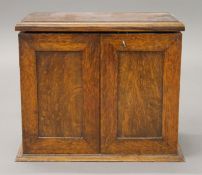 An early 20th century oak smoker's cabinet. 37 cm wide.