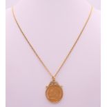 A 1911 half sovereign on a 9 ct gold chain and mount. Chain 50 cm long. 9 grammes total weight.