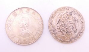 A Republic of Mexico silver coin and a Memento of the Birth of The Republic of China coin.