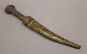 An Eastern horn handled dagger in brass scabbard. 26.5 cm long.
