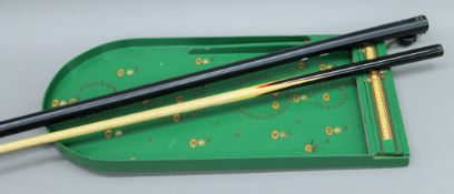 A snooker que and a bagatelle board.