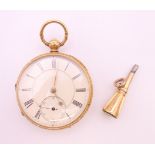 An 18 ct gold pocket watch with key, hallmarked Chester 1875. 5 cm diameter. The watch 95.