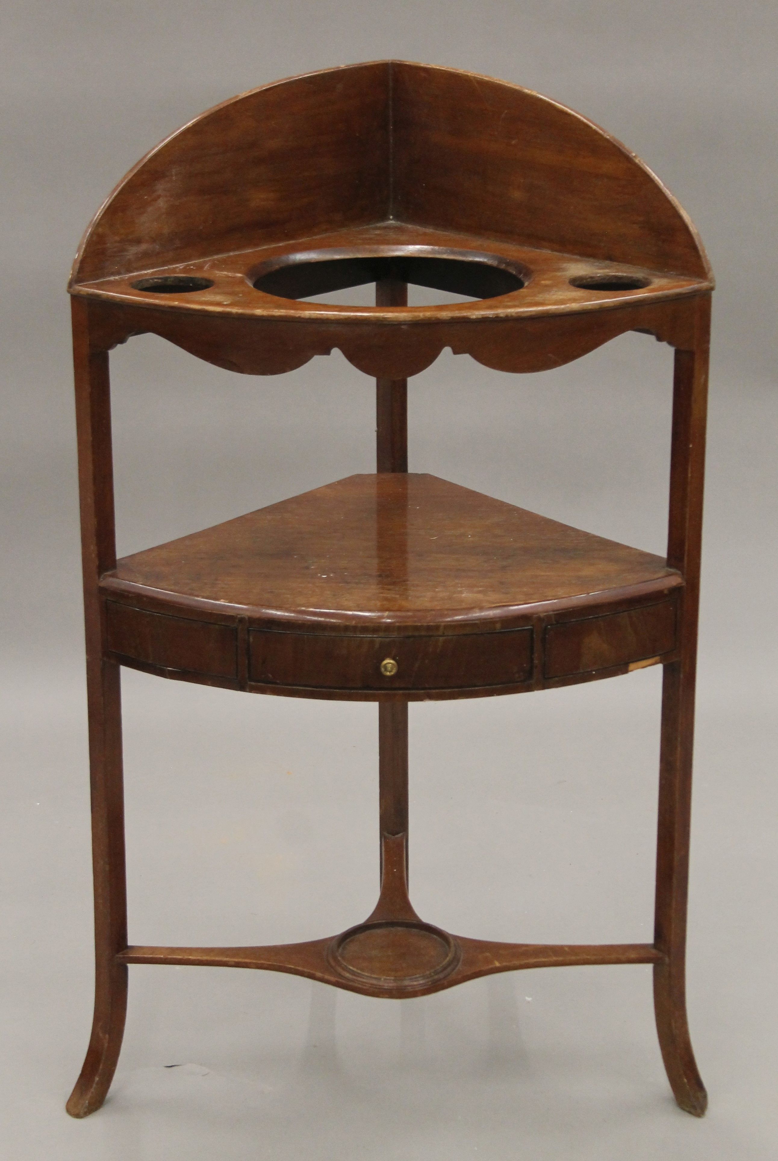 A George III mahogany corner washstand. 60 cm wide.