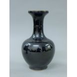 A Chinese porcelain black ground vase. 23 cm high.
