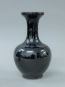 A Chinese porcelain black ground vase. 23 cm high.