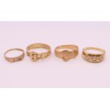 Four 9 ct gold rings. 13.4 grammes total weight.