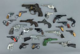 A box of toy cap guns, keyring guns, some early cast iron, etc.