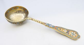 A silver and enamel sifter spoon, bearing Russian marks. 16.5 cm long. 72.4 grammes total weight.