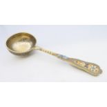 A silver and enamel sifter spoon, bearing Russian marks. 16.5 cm long. 72.4 grammes total weight.