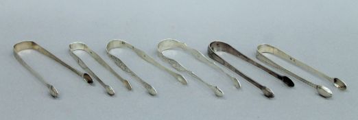 Six pairs of Georgian bright cut engraved silver sugar tongs, various makers, etc. 198.8 grammes.