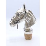 A bottle stopper in the form of a horse's head, signed 'Calero'. 11.5 cm high including stopper, 8.