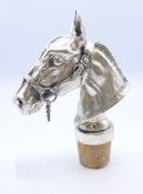 A bottle stopper in the form of a horse's head, signed 'Calero'. 11.5 cm high including stopper, 8.
