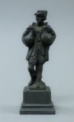 A patinated bronze figure of a man and ducks. 15 cm high.