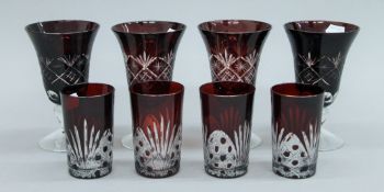A set of four ruby cut glass rummers and four tumblers. The former each 15.5 cms high.
