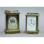 Two brass carriage clocks. The largest 16 cm high.