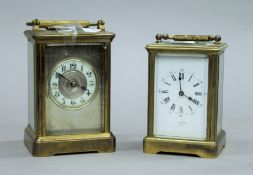 Two brass carriage clocks. The largest 16 cm high.