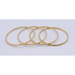 Four 22 ct gold bangles. 6 cm internal diameter. 53.1 grammes total weight.