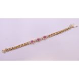 A 14 ct gold ruby and diamond bracelet. 17.5 cm long. 17.2 grammes total weight.