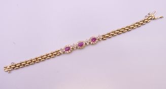 A 14 ct gold ruby and diamond bracelet. 17.5 cm long. 17.2 grammes total weight.