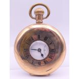 A gold plated half hunter pocket watch. 5 cm diameter.