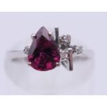 An 18 K white gold ruby and diamond ring. Ring size J. 2.4 grammes total weight.