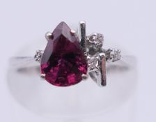 An 18 K white gold ruby and diamond ring. Ring size J. 2.4 grammes total weight.