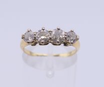 An unmarked gold four stone diamond ring. Ring size O. 2.7 grammes total weight.