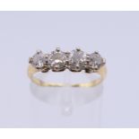 An unmarked gold four stone diamond ring. Ring size O. 2.7 grammes total weight.