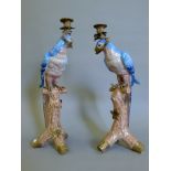 Two metal mounted porcelain candlesticks formed as parrots. The largest 51.5 cm high.