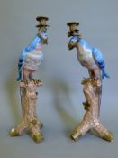 Two metal mounted porcelain candlesticks formed as parrots. The largest 51.5 cm high.