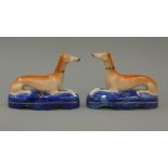 A pair of 19th century Staffordshire pottery models of coursing greyhounds,