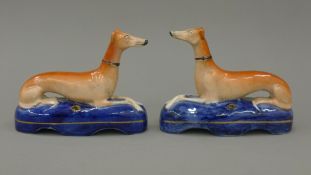 A pair of 19th century Staffordshire pottery models of coursing greyhounds,