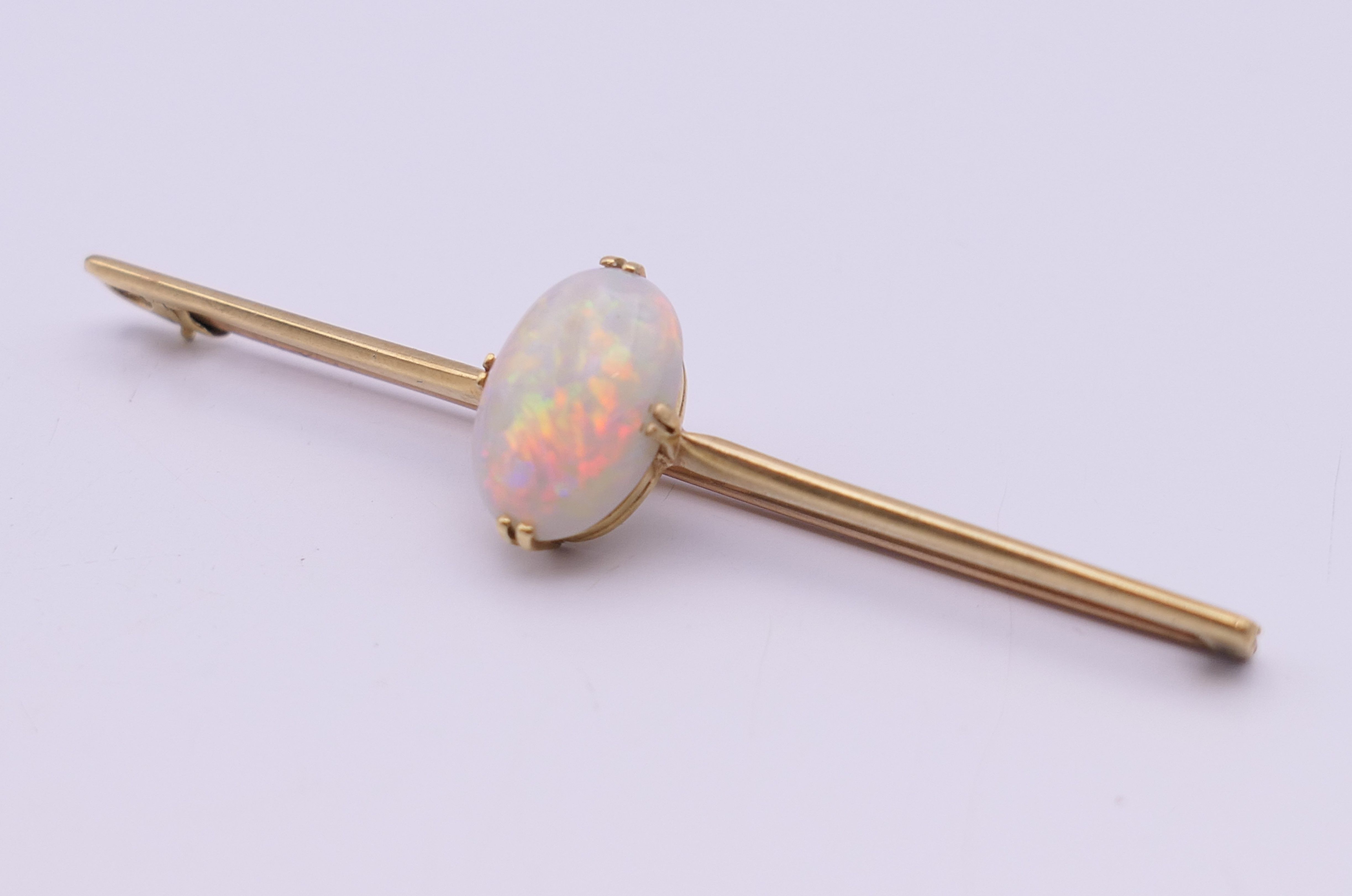 A 15 ct gold opal set bar brooch. 7 cm long, opal 1.5 cm high. 5.3 grammes total weight. - Image 2 of 9