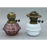 Two Victorian hanging oil lamp reservoirs. Each approximately 18.5 cm high.