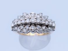 An unmarked gold and diamond cluster ring. Ring size P. 5.6 grammes total weight.