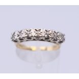A 9 ct gold seven stone diamond ring. Ring size N/O. 2.5 grammes total weight.