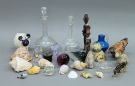 A box of various miscellaneous items, including decanters, sea shells, etc.