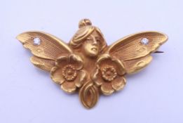A 10 ct gold diamond set Art Nouveau brooch formed as a fairy. 3.5 cm wide. 3.