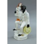 A 19th century Staffordshire pottery model of Uncle Tom and Little Eva. 27 cm high.