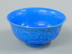 A Chinese blue porcelain dragon bowl. 15 cm diameter.