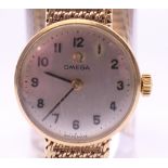 An Omega lady's 9 ct gold wristwatch. 2 cm diameter. 18.9 grammes total weight.